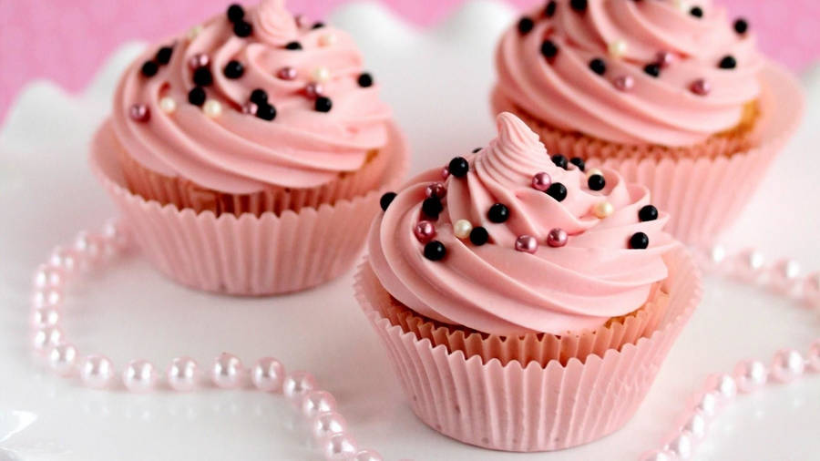 Indulgent Pink Cupcake With Sprinkles Wallpaper