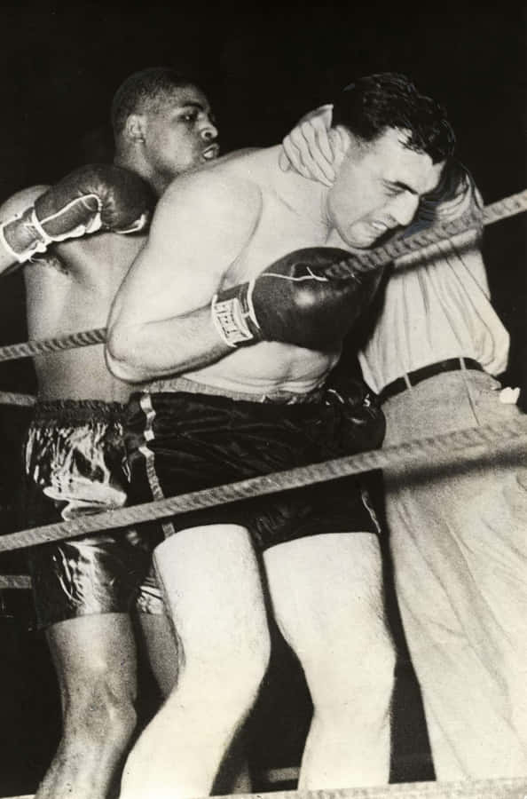 Italian Boxer Primo Carnera Holding On To The Ropes Wallpaper
