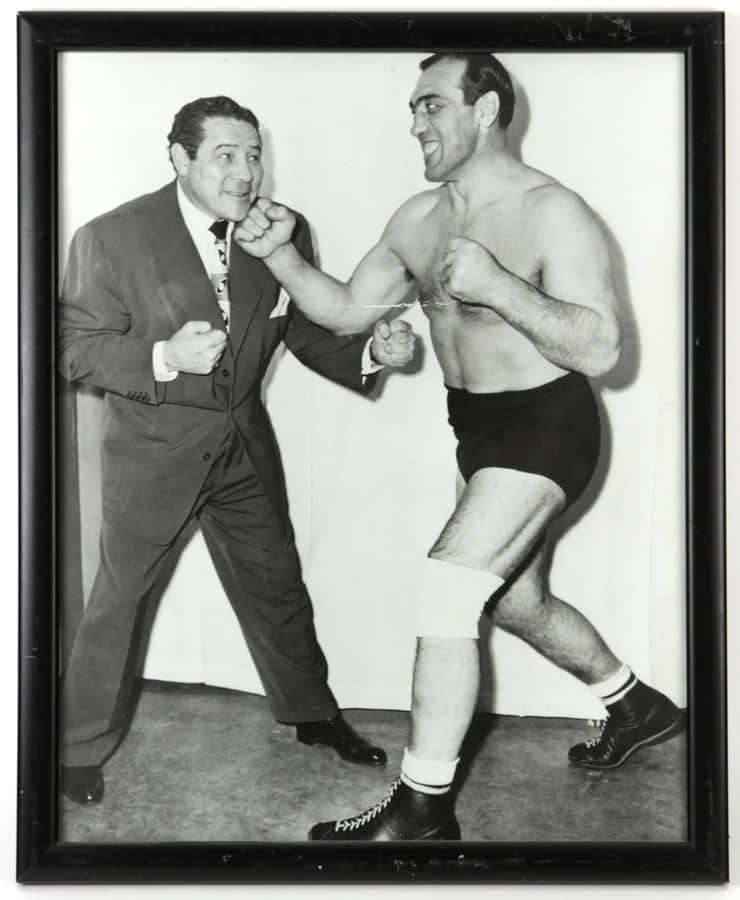 Italian Professional Boxer Primo Carnera In A Boxing Stance Wallpaper