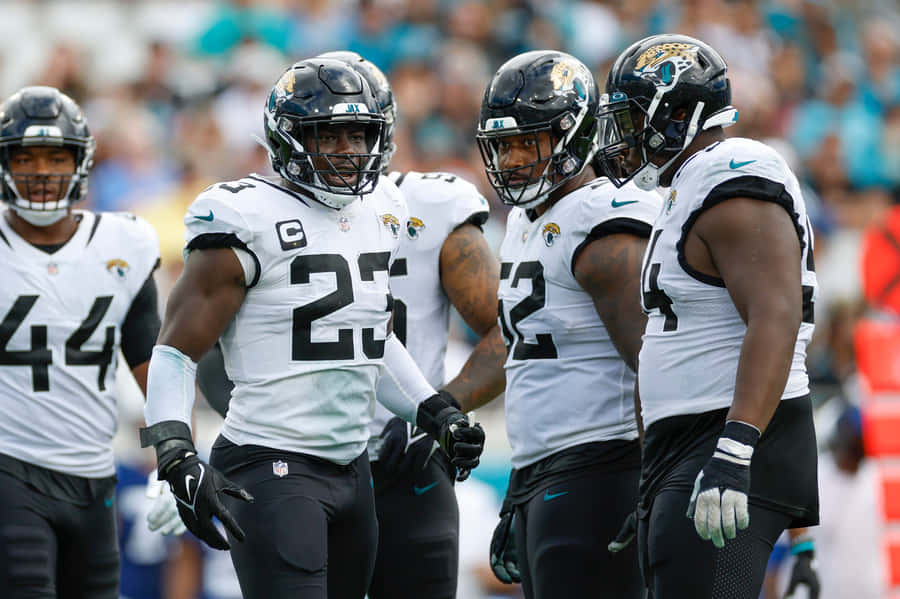 Jaguars Team Captainand Players Walkingon Field Wallpaper