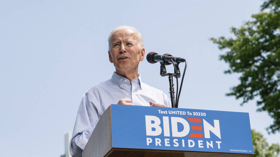 Joe Biden Delivers Powerful Speech On Stage Wallpaper