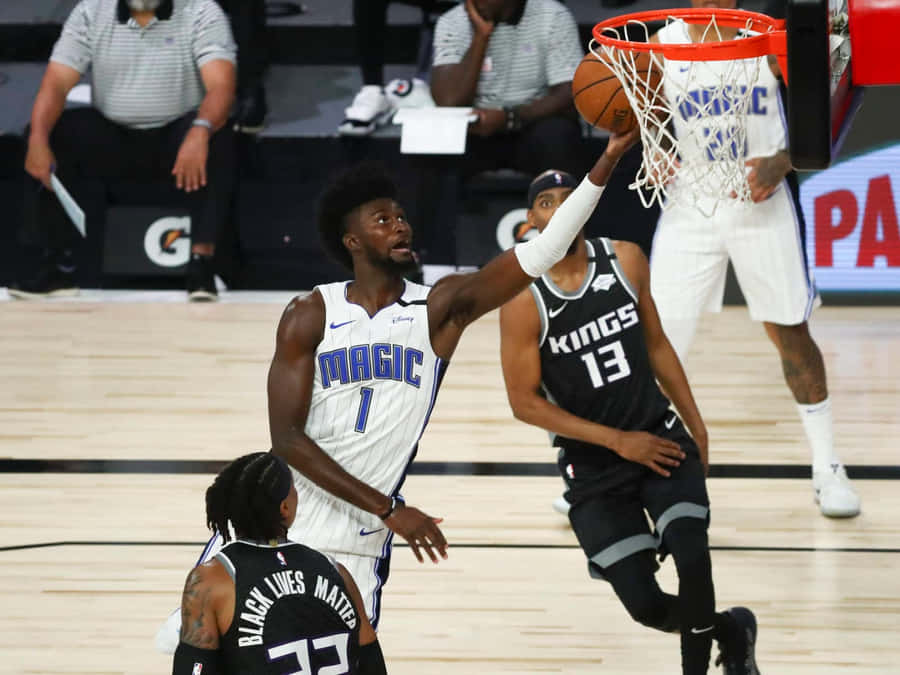 Jonathan Isaac Reaching Basketball Ring Wallpaper