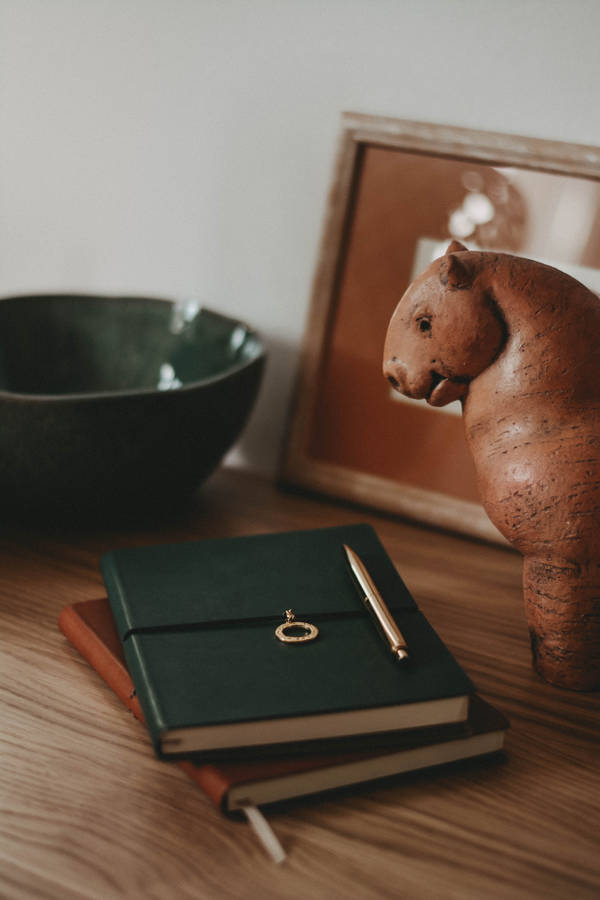 Journals And Figurine Wallpaper