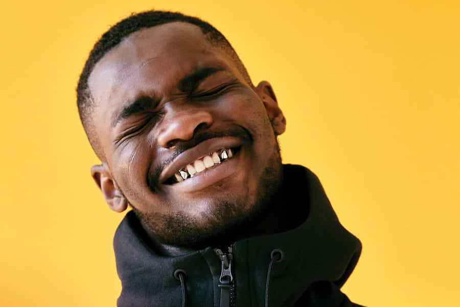 Joyful Man Squinting Smile Yellow Background Wallpaper