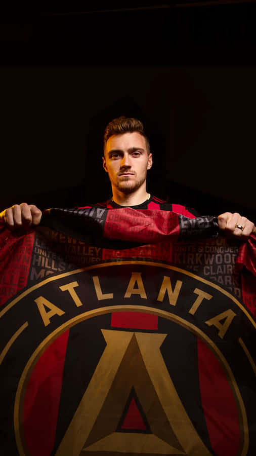 Julian Gressel Holding Atlanta United Fc Flag Wallpaper