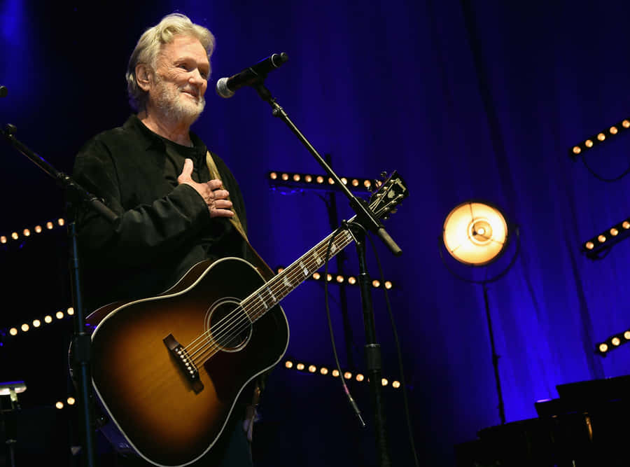 Kris Kristofferson On Stage With Guitar Wallpaper