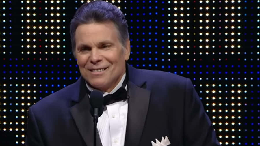 Lanny Poffo Smiling In Black Suit Wallpaper