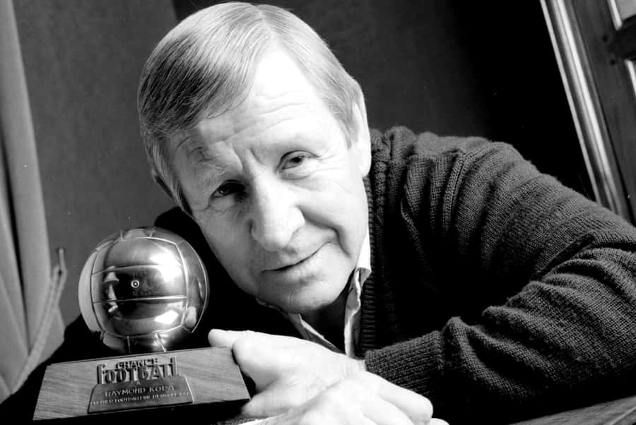 Legendary Footballerwith Trophy Wallpaper