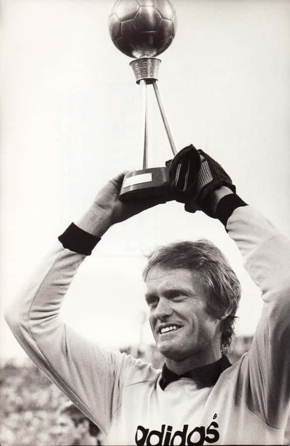 Legendary German Goalkeeper Sepp Maier Holding A Football Trophy. Wallpaper