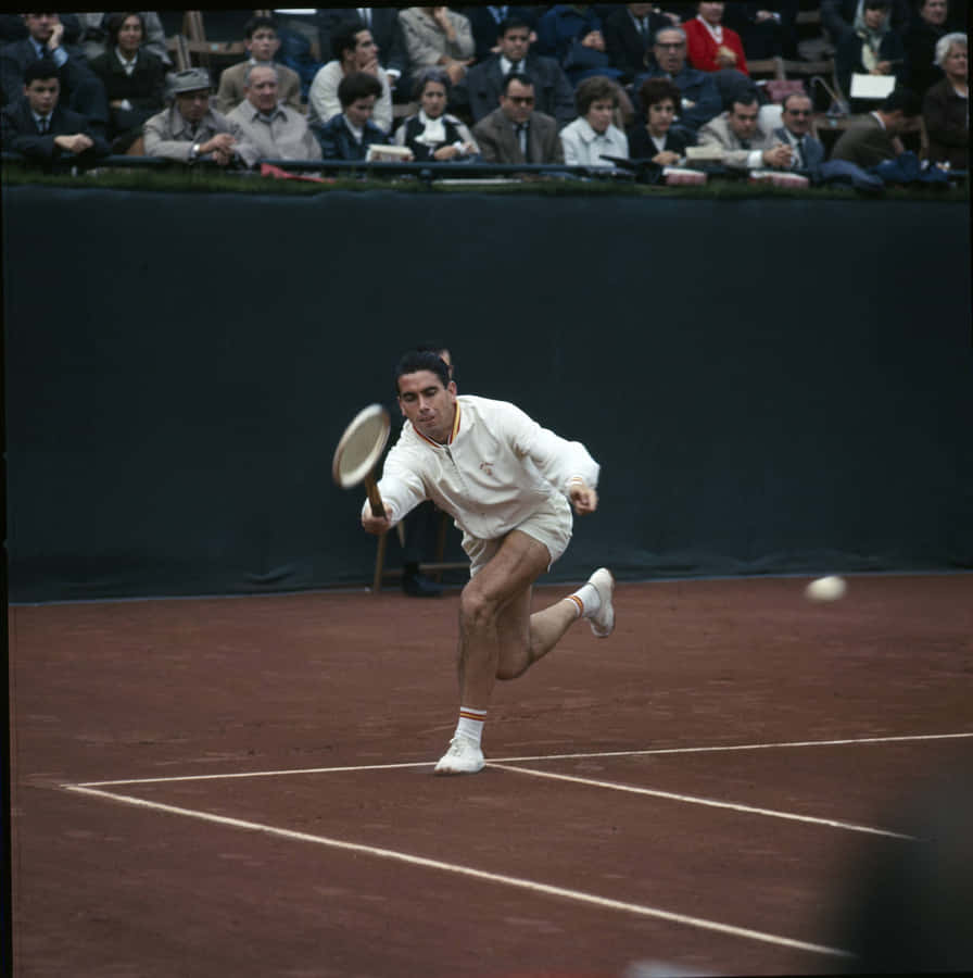 Legendary Tennis Champion Manuel Santana In Action Wallpaper