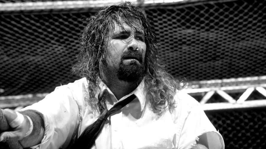 Legendary Wwe Wrestler Mick Foley In The Middle Of A Sensational Match In 1998. Wallpaper