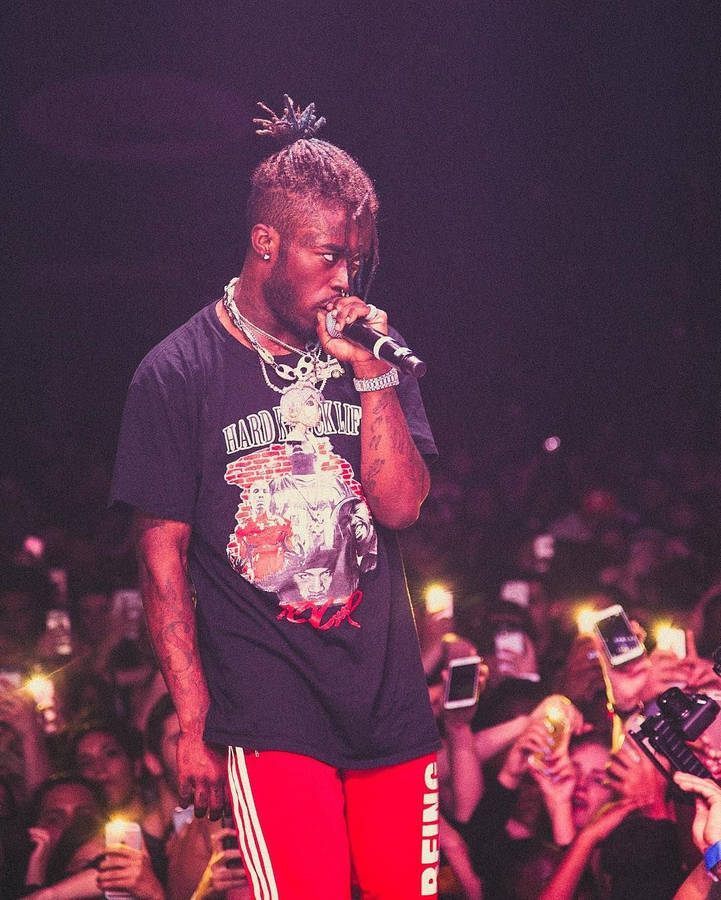 Lil Uzi Vert On The Stage At A Concert Wallpaper
