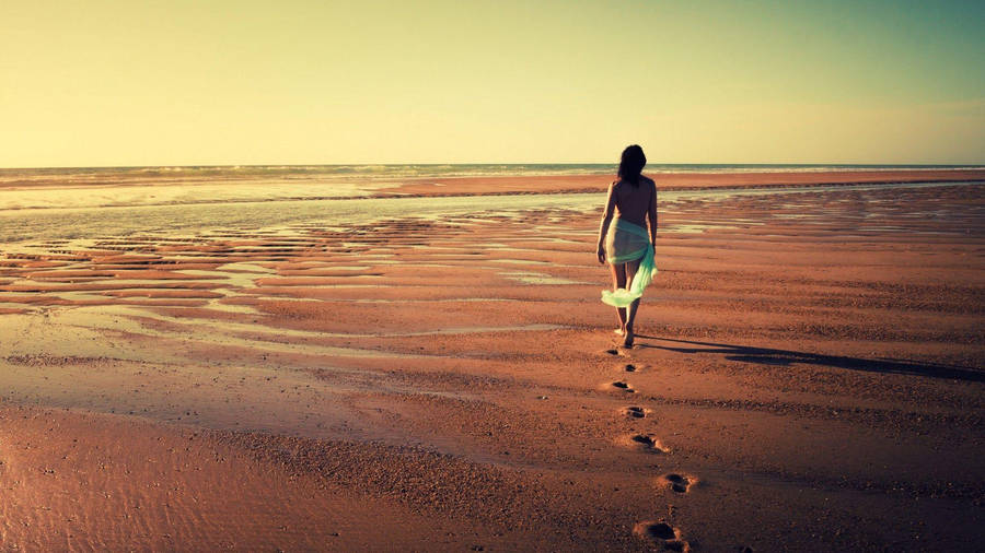 Lone Girl Embracing Solitude In The Vast Wilderness Wallpaper