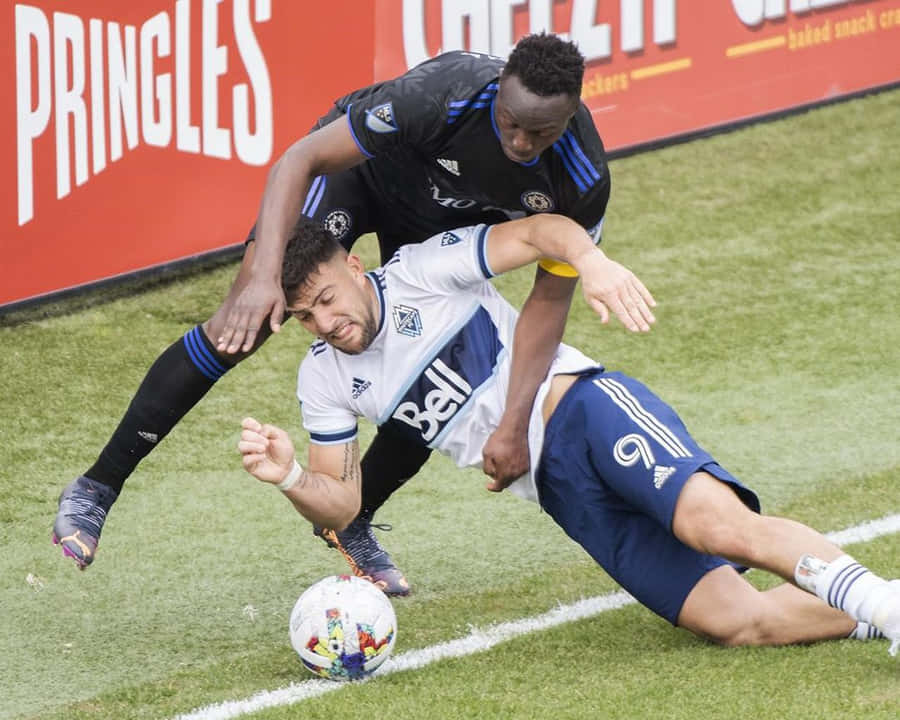 Lucas Cavallini Tackled Football Game Wallpaper