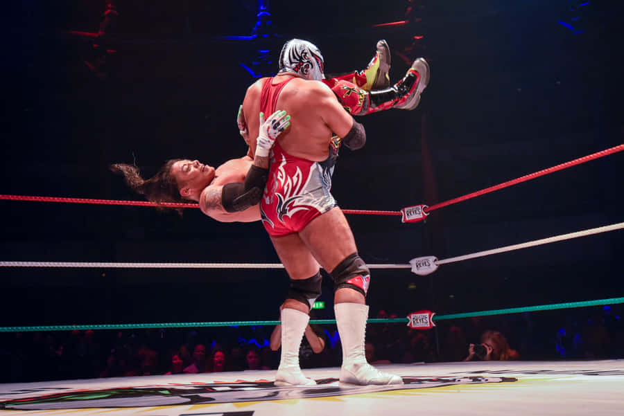 Luchador Performing Suplex Move Wrestling Match Wallpaper