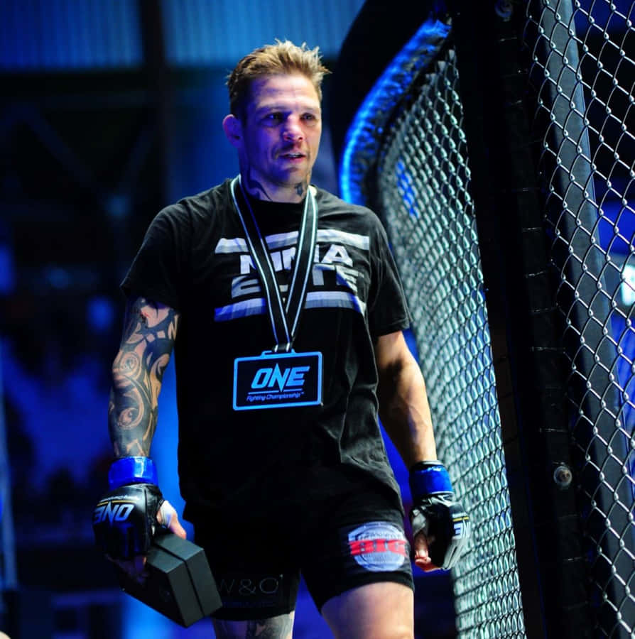 M M A Fighter Beside Cage Octagon Wallpaper