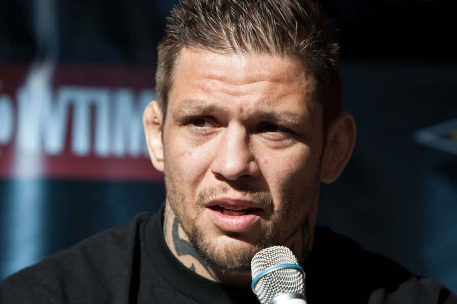 M M A Fighter Speakingat Press Conference Wallpaper