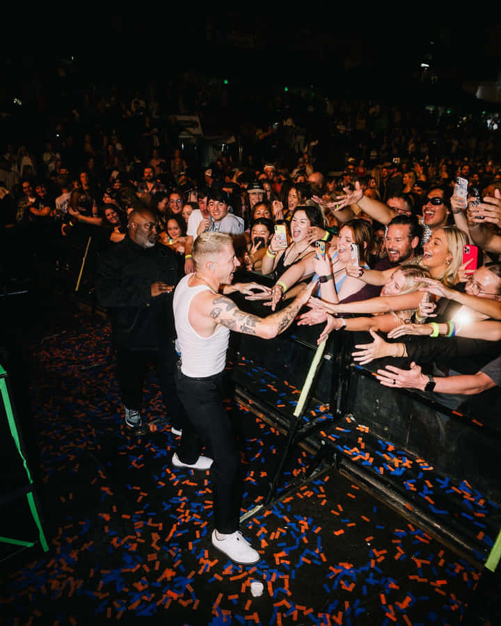 Macklemore Engagingwith Fans During Concert Wallpaper