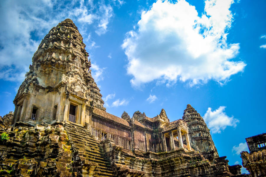 Majestic Angkor Wat Under A Brilliant Blue Sky Wallpaper