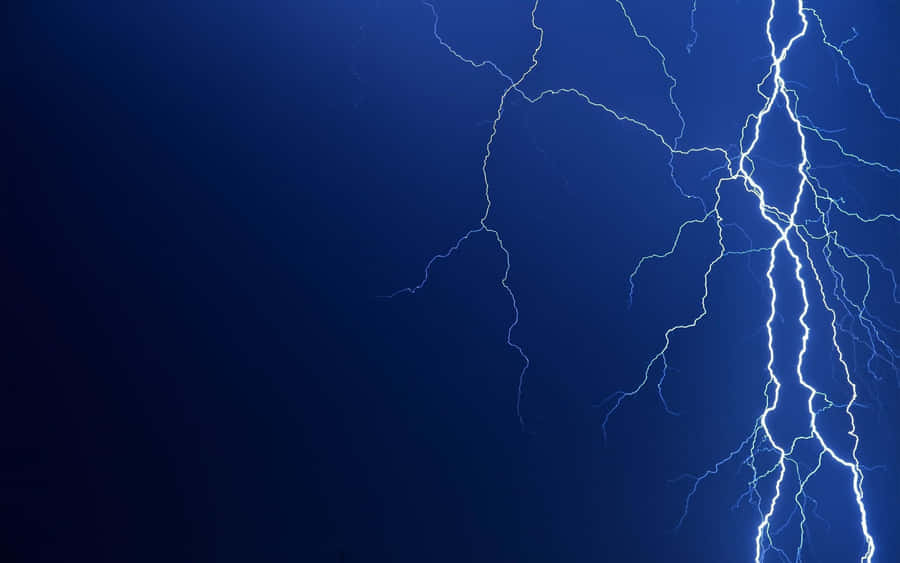 Majestic Cool Lightning Illuminating The Night Sky Wallpaper