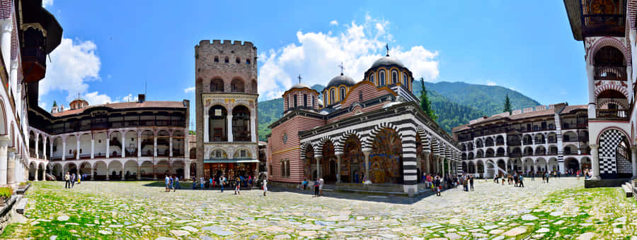 Majestic View Of Rila Monastery Under Clear Skies Wallpaper