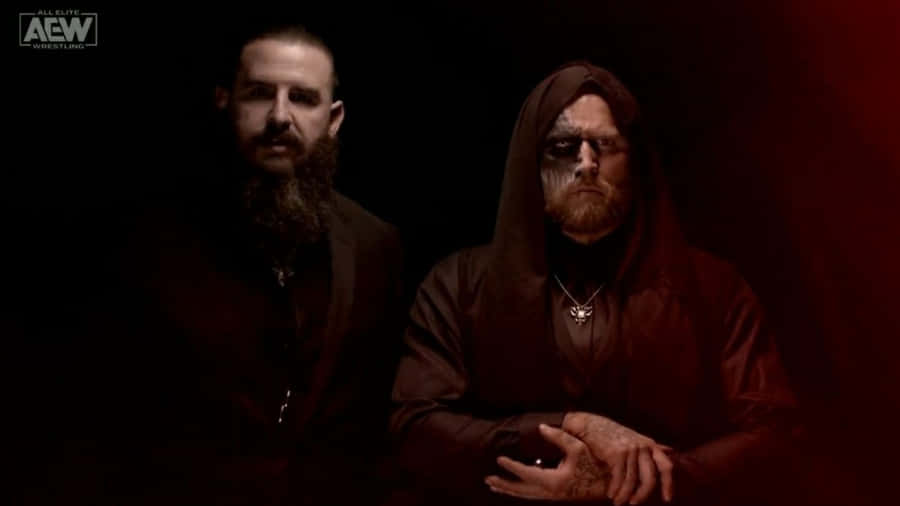 Malakai Black With Brodie King In Dimly Lit Room Wallpaper