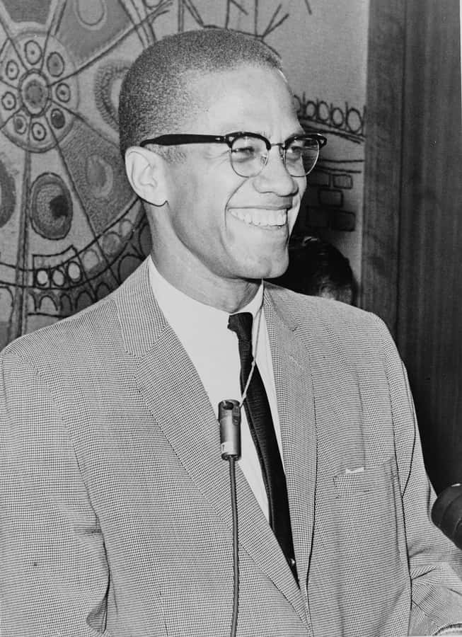 Malcolm X Smiling Blackand White Portrait Wallpaper