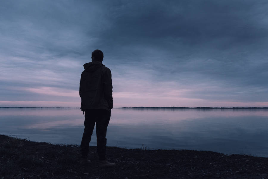 Man By Calm Waters Sad 4k Wallpaper