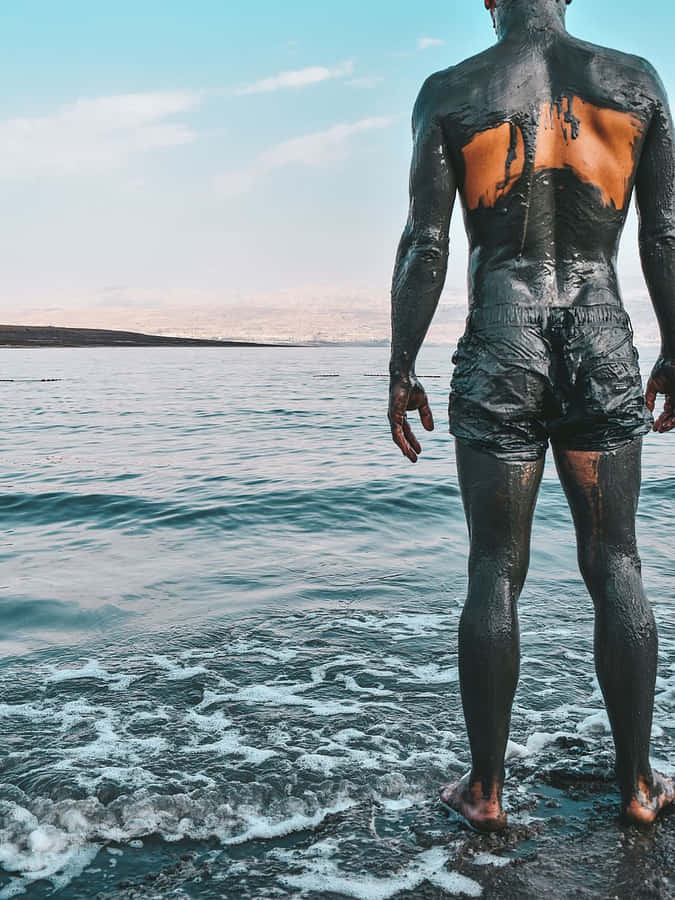 Man Covered In Dead Sea Mud Wallpaper