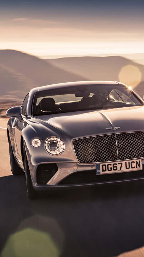 Man Driving A Bentley Iphone Wallpaper