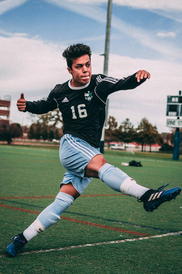 Man Wearing Black And Blue Jersey Shirt On Field Wallpaper