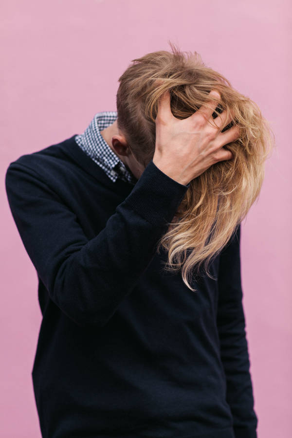 Man Wearing Black Crew-neck Sweatshirt With Hand Running Through Hair Wallpaper