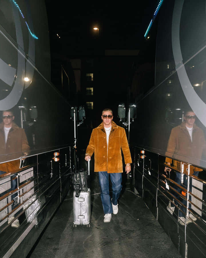 Manwith Sunglassesand Suitcase Wallpaper