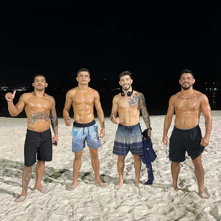Matheus Nicolau With Friends At Beach Wallpaper
