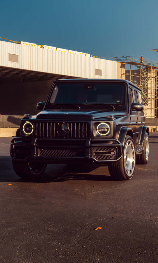 Matte Black Luxury S U V Parked Outdoors Wallpaper