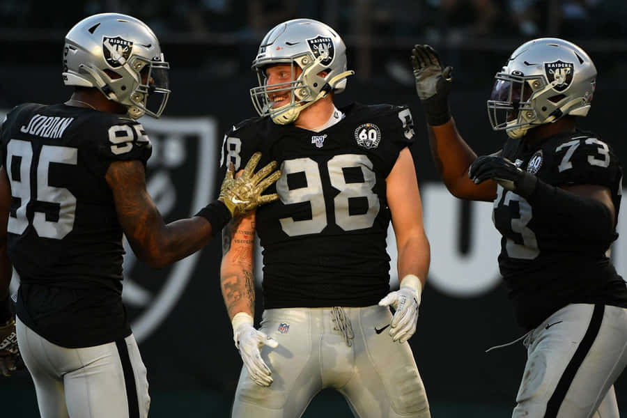 Maxx Crosby Celebrating With Raiders Teammates. Wallpaper