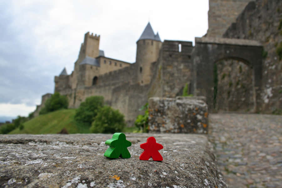 Meeples Outside The Castle In Carcassonne France Wallpaper