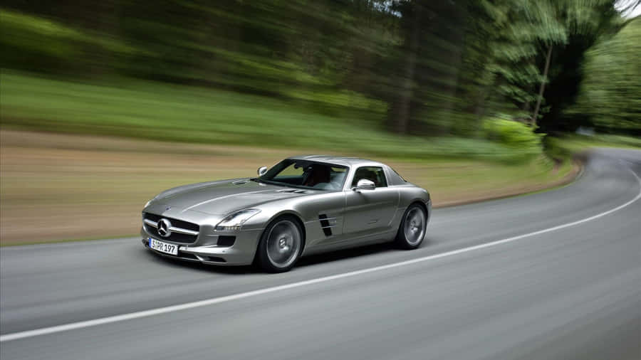 Mercedes Sls Amg Driving Down A Road Wallpaper