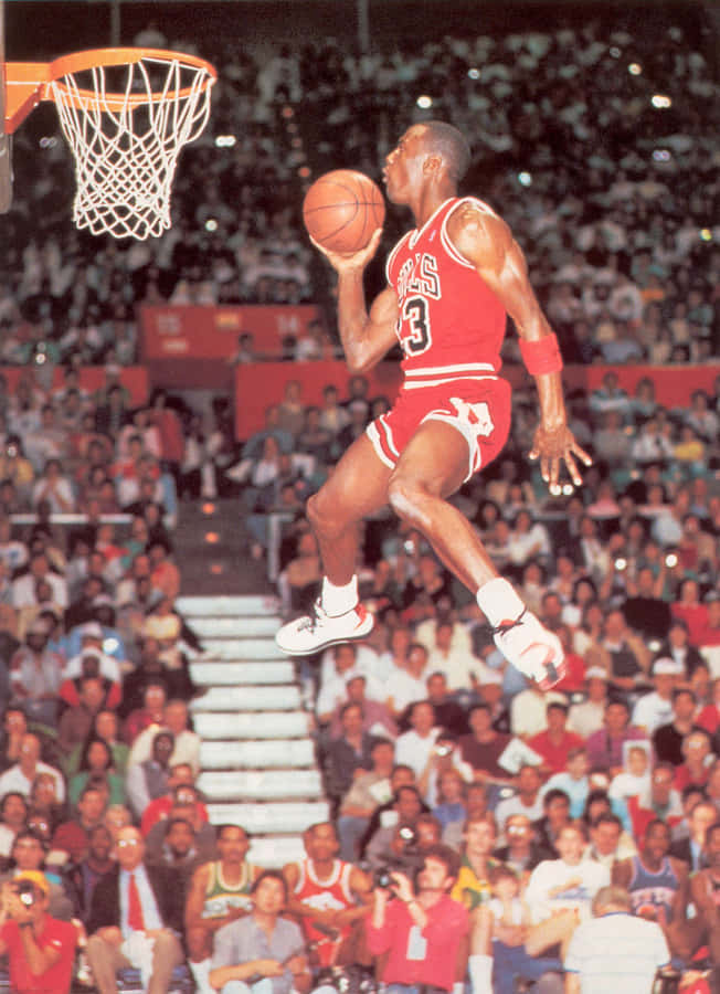 Michael Jordan In Midair During A Gravity-defying Dunk Wallpaper