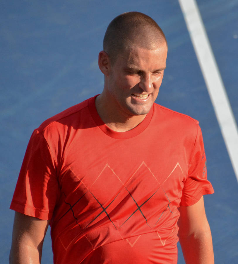 Mikhail Youzhny In Action - The Russian Tennis Maestro In Red Wallpaper