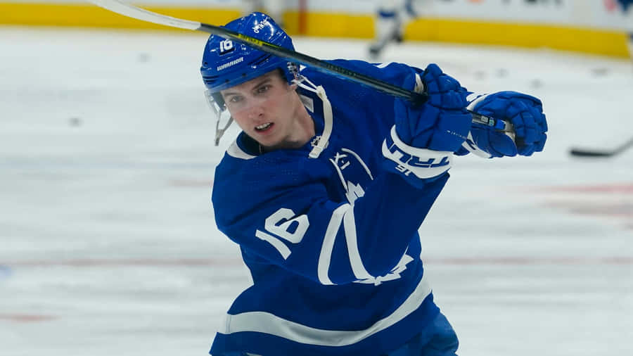 Mitchell Marner Hitting A Puck Wallpaper