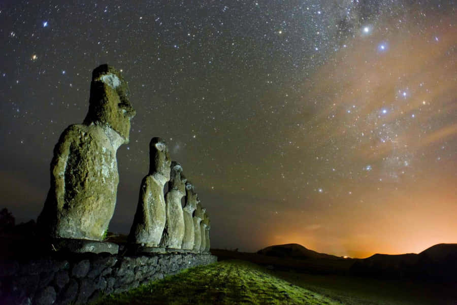 Moai Statues Across Shiny Stars Wallpaper