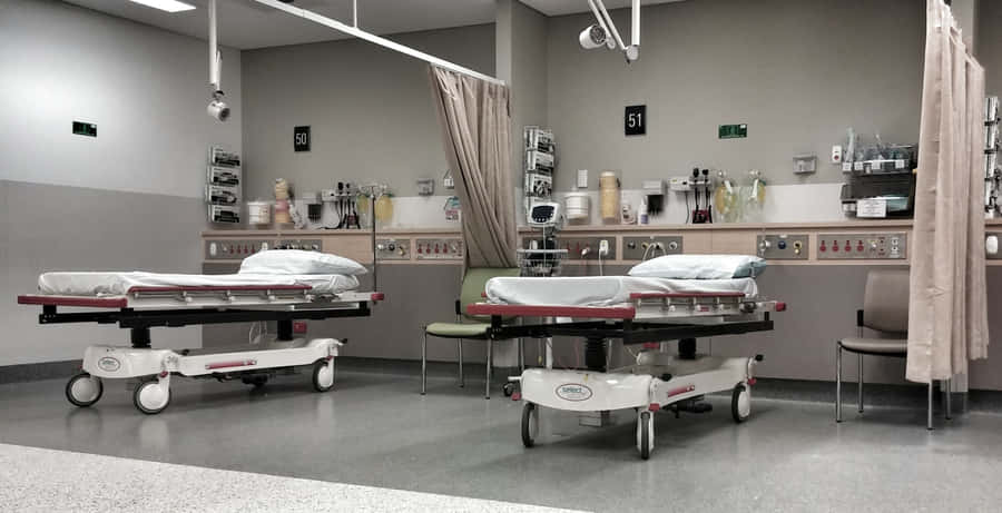 Modern Hospital Bed In Emergency Room Wallpaper