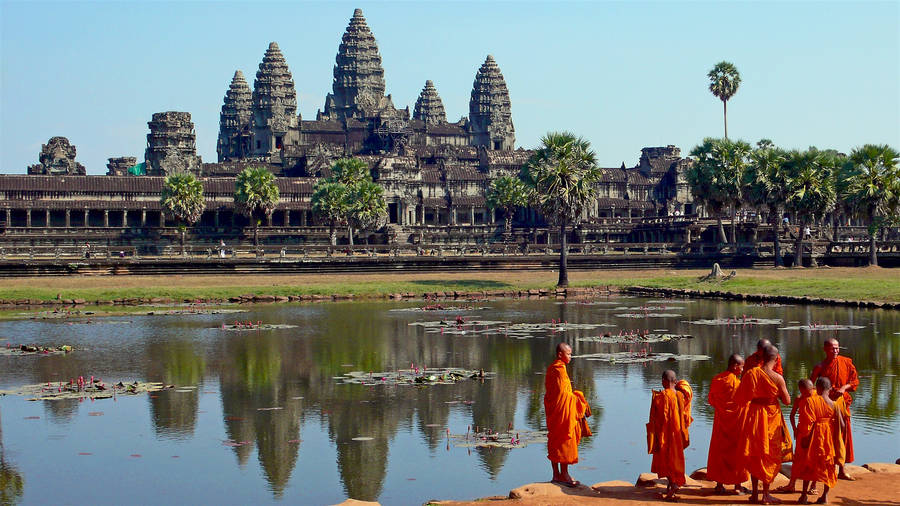 Monks Outside Angkor Wat In Cambodia Wallpaper
