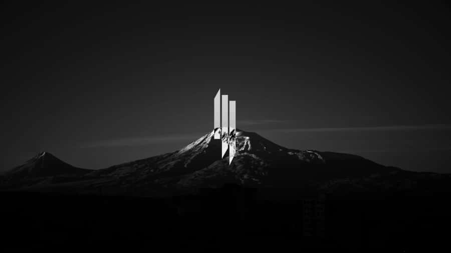 Monolithic_ Structure_on_ Snowy_ Mountain_ Peak_4 K Wallpaper