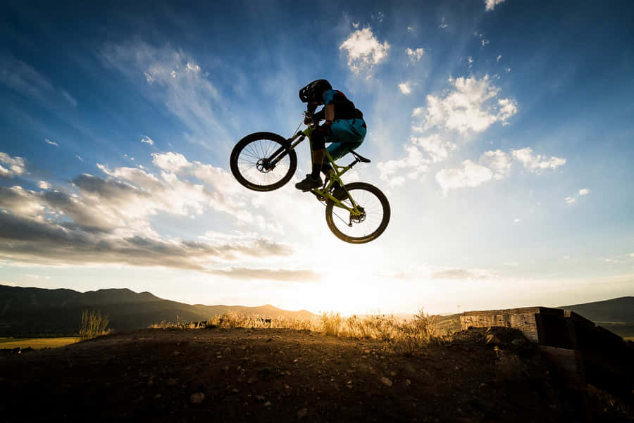 Mountain Biker Sunset Jump Wallpaper