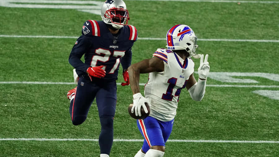 New England Patriots Cornerback Jc Jackson Running After Stephen Diggs Wallpaper