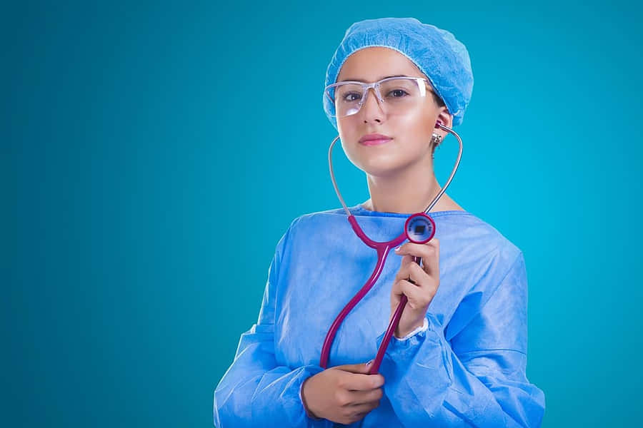 Nursing Wearing Her Ppe And Stethoscope Wallpaper