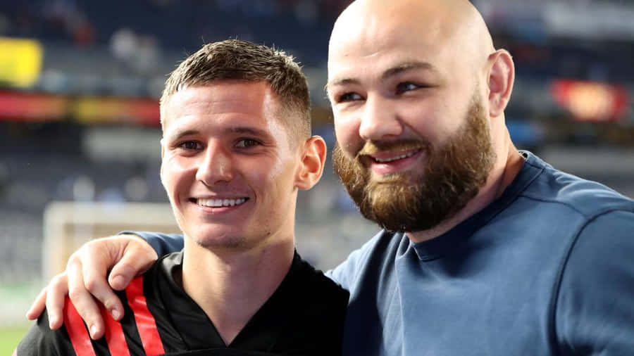 Patryk Klimala Smilingwith Fan Wallpaper