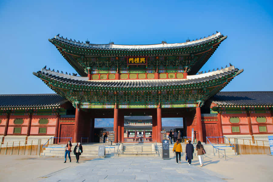 People Entering And Exiting Gyeongbokgung Palace Wallpaper